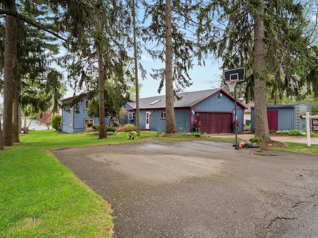 ranch-style home featuring driveway and a front yard