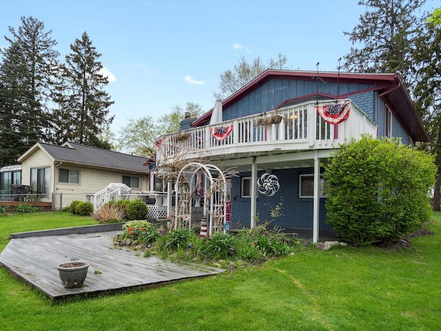 back of house with a wooden deck, a chimney, and a yard
