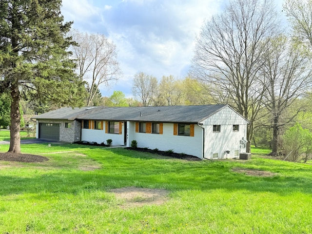 ranch-style house with a garage, aphalt driveway, a front yard, and cooling unit