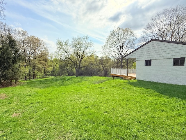 view of yard featuring a wooden deck