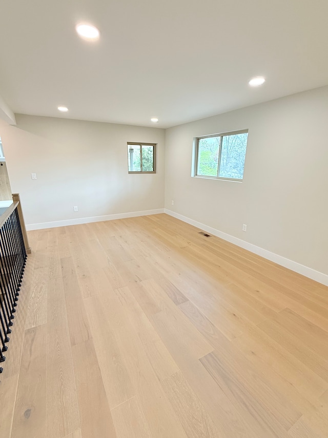 basement featuring baseboards, recessed lighting, and light wood-style flooring