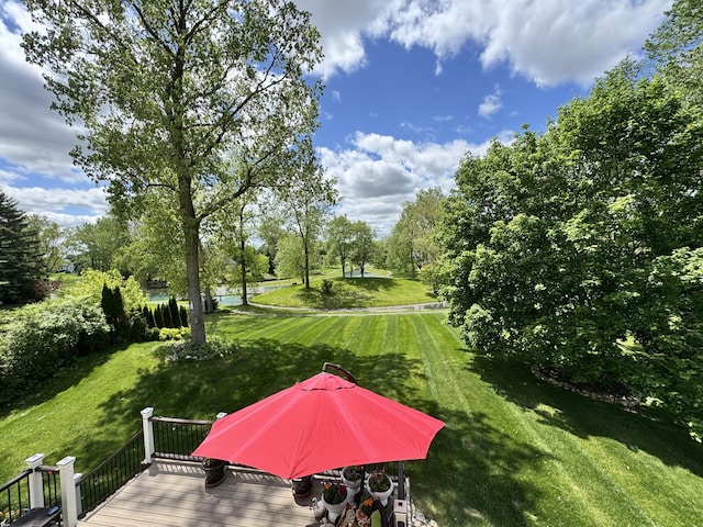 5644 Lohr Lake Dr, Ann Arbor, MI 48108 - view of grassy yard featuring a wooden deck and view of wooded area