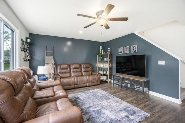 living room with a ceiling fan, baseboards, and dark wood-style floors