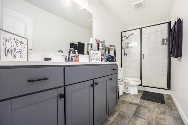full bath featuring visible vents, a stall shower, wood finished floors, vanity, and toilet