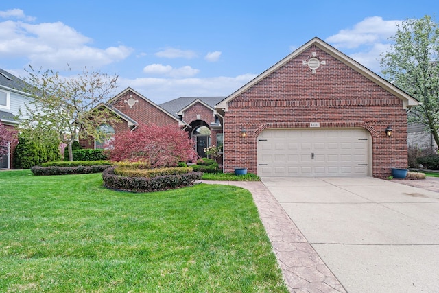 view of front of home with brick siding, an attached garage, driveway, and a front yard