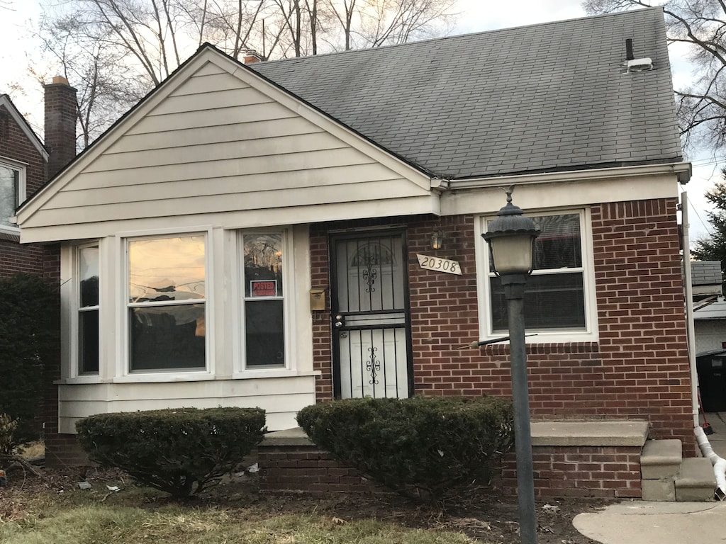 20308 Greydale Ave, Detroit, MI 48219 - view of front facade featuring brick siding and a shingled roof