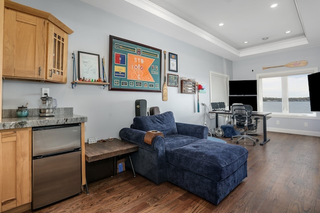 living room featuring ornamental molding, a raised ceiling, dark wood-style floors, and recessed lighting