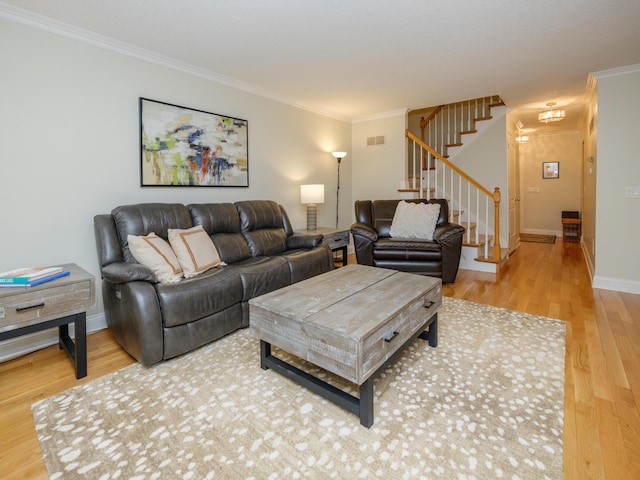 living room with crown molding, visible vents, stairs, wood finished floors, and baseboards