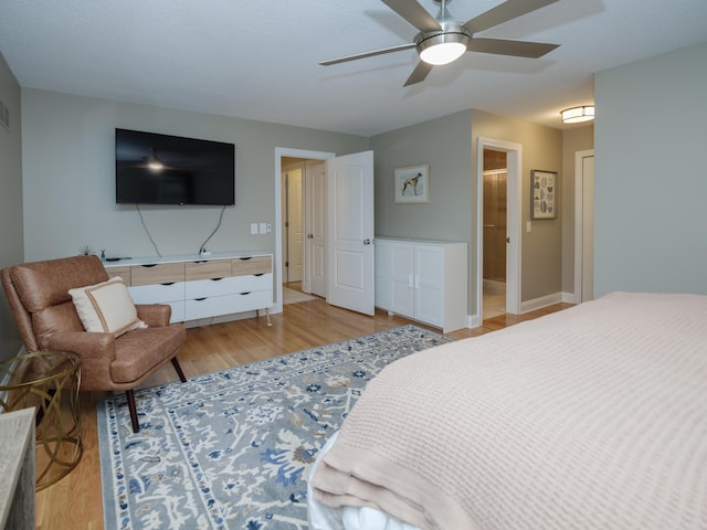 bedroom featuring light wood-style floors, baseboards, ceiling fan, and visible vents