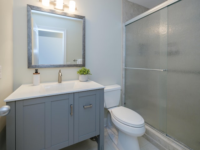 full bath with vanity, tile patterned flooring, a stall shower, and toilet