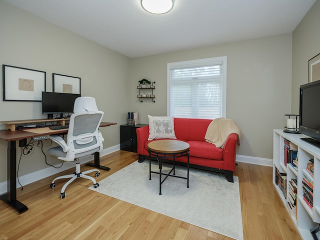 office area with baseboards and wood finished floors