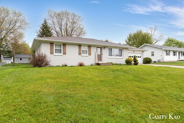 7116 Linden Ave SE, Grand Rapids, MI 49548 - single story home featuring concrete driveway, brick siding, an attached garage, and a front yard