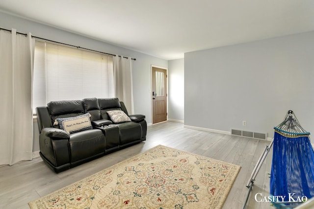 7116 Linden Ave SE, Grand Rapids, MI 49548 - living area with visible vents, baseboards, and wood finished floors