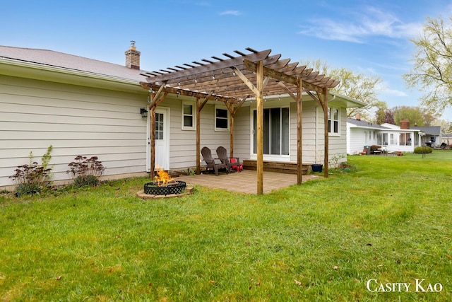 7116 Linden Ave SE, Grand Rapids, MI 49548 - back of property featuring a fire pit, a pergola, a patio, a chimney, and a yard