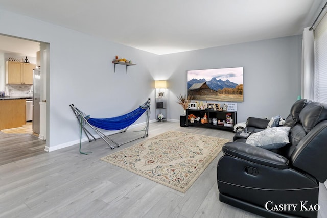 7116 Linden Ave SE, Grand Rapids, MI 49548 - living area featuring baseboards and light wood finished floors