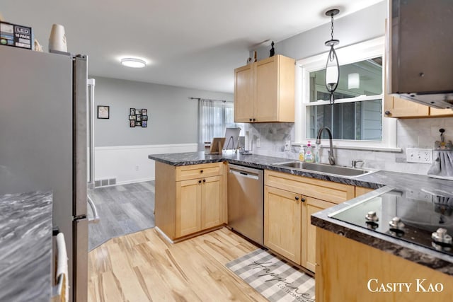 7116 Linden Ave SE, Grand Rapids, MI 49548 - kitchen featuring a sink, appliances with stainless steel finishes, light brown cabinets, and a peninsula