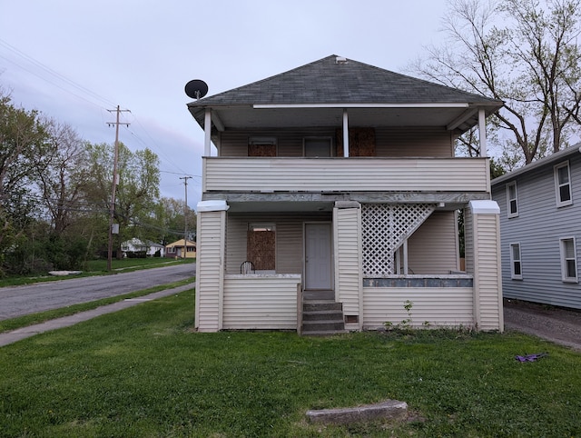 249 W Wilson Ave, Pontiac, MI 48341 - rear view of property featuring a shingled roof, a yard, a porch, and a balcony