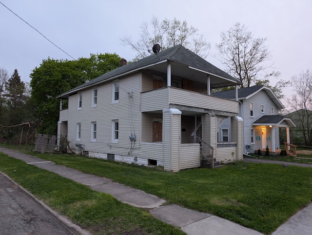 249 W Wilson Ave, Pontiac, MI 48341 - view of side of property with a lawn, a balcony, and a chimney
