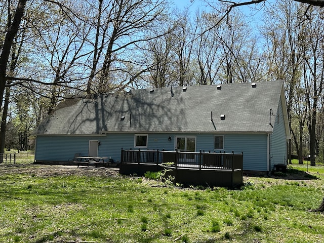 9615 Woodland Ct, Ypsilanti, MI 48197 - rear view of house with a lawn, a wooden deck, and roof with shingles