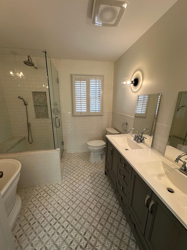 9615 Woodland Ct, Ypsilanti, MI 48197 - bathroom featuring wainscoting, a sink, a freestanding tub, tile walls, and a shower stall