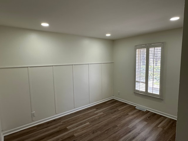9615 Woodland Ct, Ypsilanti, MI 48197 - unfurnished room with recessed lighting, a decorative wall, dark wood-style floors, and visible vents