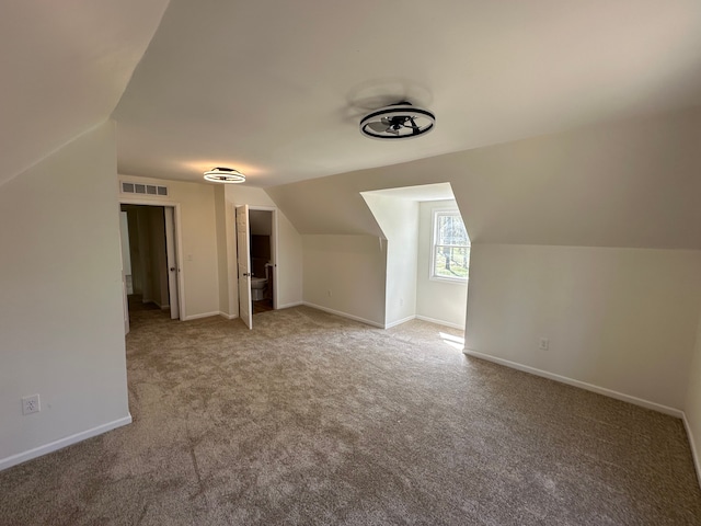 9615 Woodland Ct, Ypsilanti, MI 48197 - additional living space featuring baseboards, visible vents, carpet, and vaulted ceiling