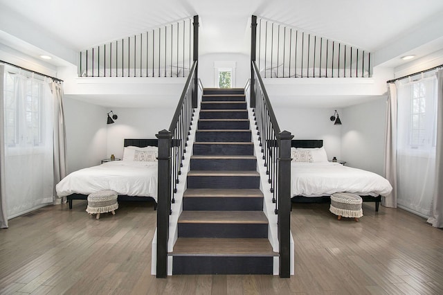 bedroom featuring high vaulted ceiling, recessed lighting, and wood finished floors
