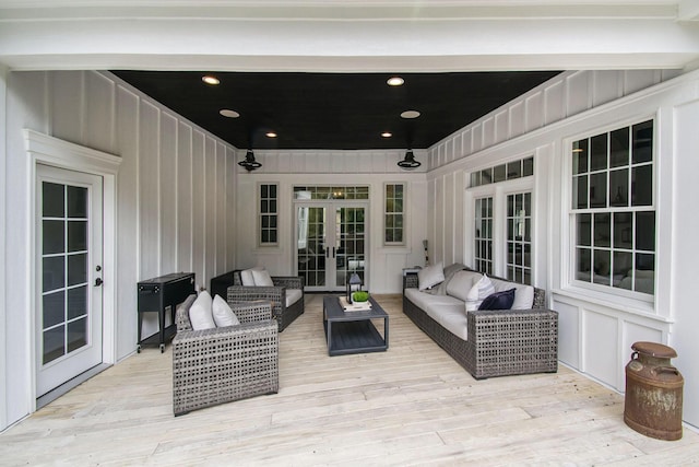 wooden terrace featuring an outdoor living space and french doors