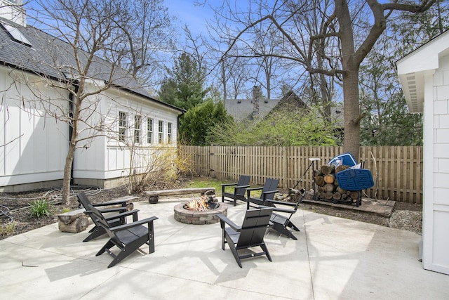 view of patio featuring fence and a fire pit