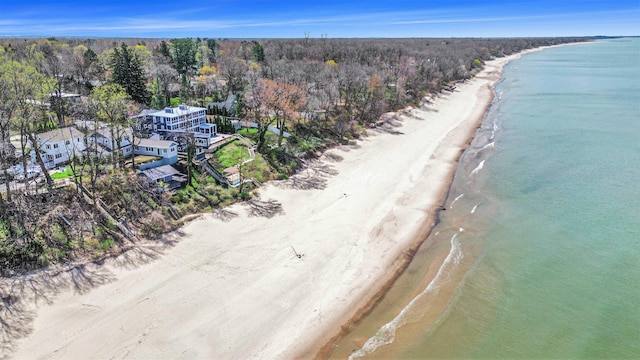 drone / aerial view featuring a water view and a view of the beach