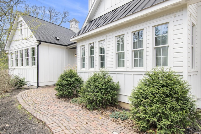view of property exterior featuring a standing seam roof and board and batten siding