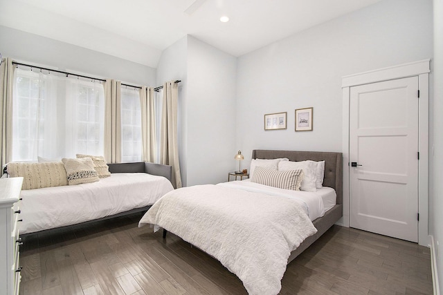 bedroom with recessed lighting, vaulted ceiling, and dark wood finished floors