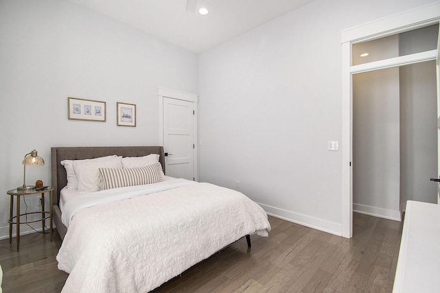 bedroom with dark wood-type flooring, recessed lighting, and baseboards