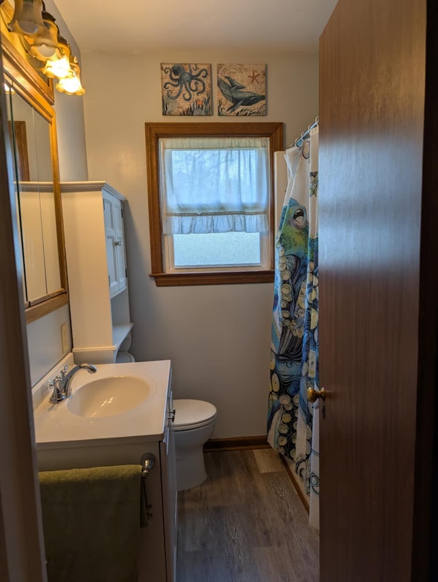 2326 Southampton Ave, Grand Blanc, MI 48507 - full bathroom with toilet, curtained shower, vanity, and wood finished floors