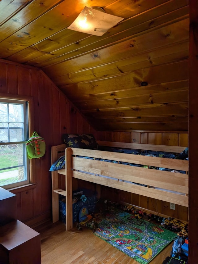 2326 Southampton Ave, Grand Blanc, MI 48507 - bedroom featuring light wood finished floors, wooden ceiling, wood walls, and lofted ceiling
