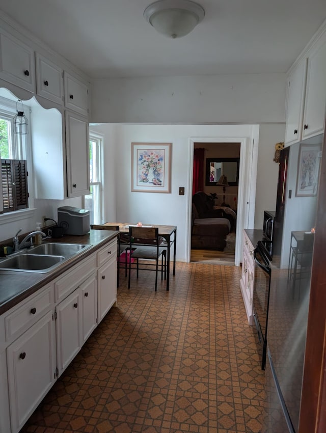 2326 Southampton Ave, Grand Blanc, MI 48507 - kitchen with a sink, dark floors, white cabinets, stove, and dark countertops