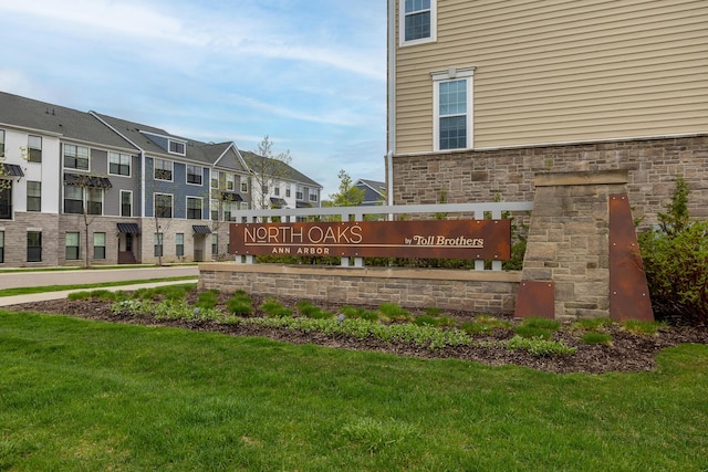 community / neighborhood sign with a yard and a residential view