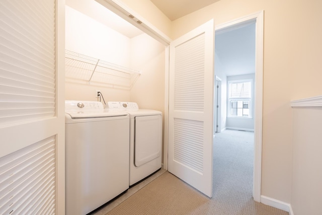 laundry area featuring separate washer and dryer, laundry area, and baseboards
