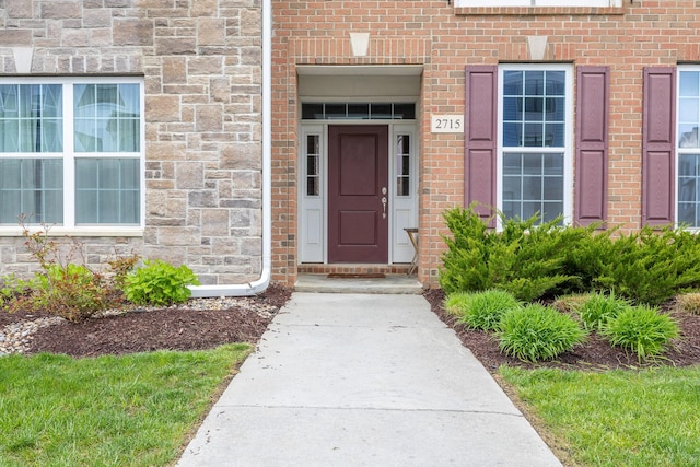 view of exterior entry with brick siding