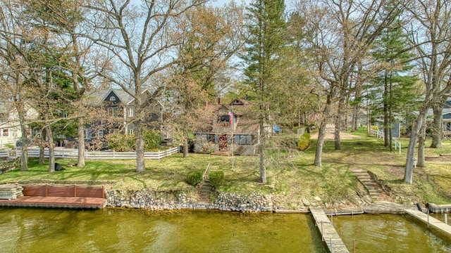 8577 Glenwood Ct, Jackson, MI 49201 - view of dock featuring a lawn, fence, and a water view
