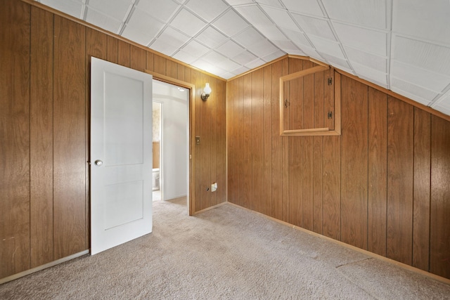 8577 Glenwood Ct, Jackson, MI 49201 - additional living space featuring vaulted ceiling, wood walls, and carpet