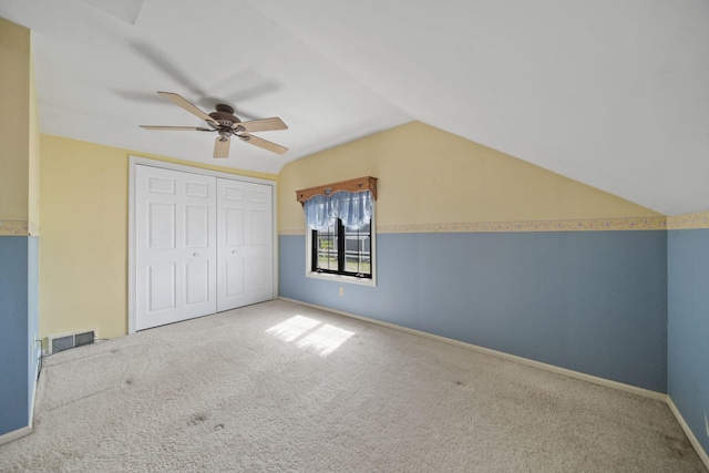 8577 Glenwood Ct, Jackson, MI 49201 - unfurnished bedroom with visible vents, a closet, lofted ceiling, baseboards, and carpet flooring