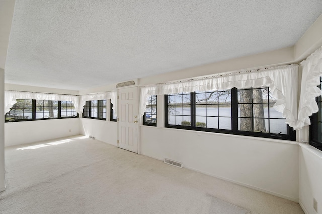 8577 Glenwood Ct, Jackson, MI 49201 - empty room with carpet floors, a textured ceiling, and visible vents
