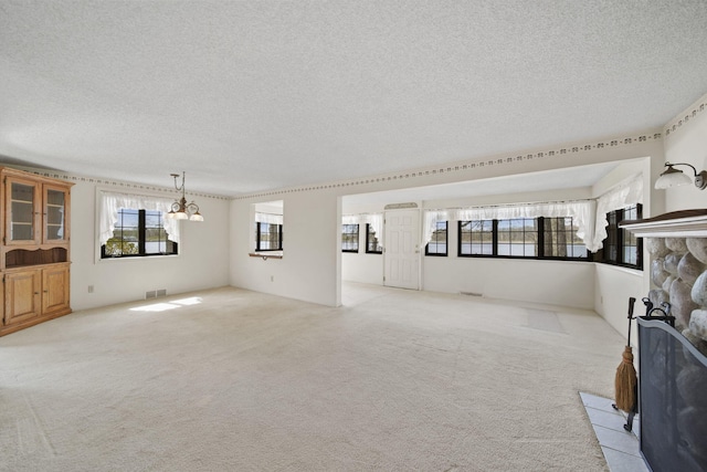 8577 Glenwood Ct, Jackson, MI 49201 - unfurnished living room featuring visible vents, light carpet, and a wealth of natural light