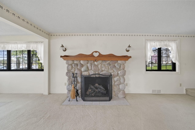 8577 Glenwood Ct, Jackson, MI 49201 - unfurnished living room with a textured ceiling, visible vents, carpet, and a fireplace