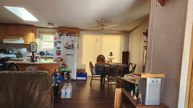 2513 Moore Dr, Allegan, MI 49010 - kitchen with under cabinet range hood, white appliances, dark wood-style floors, brown cabinets, and ceiling fan