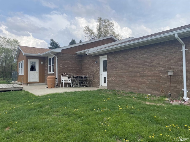 12036 S Custer, Dundee, MI 48133 - back of house with brick siding, a yard, a wooden deck, and a patio area