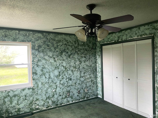 12036 S Custer, Dundee, MI 48133 - unfurnished bedroom featuring wallpapered walls, dark carpet, a closet, a textured ceiling, and ceiling fan
