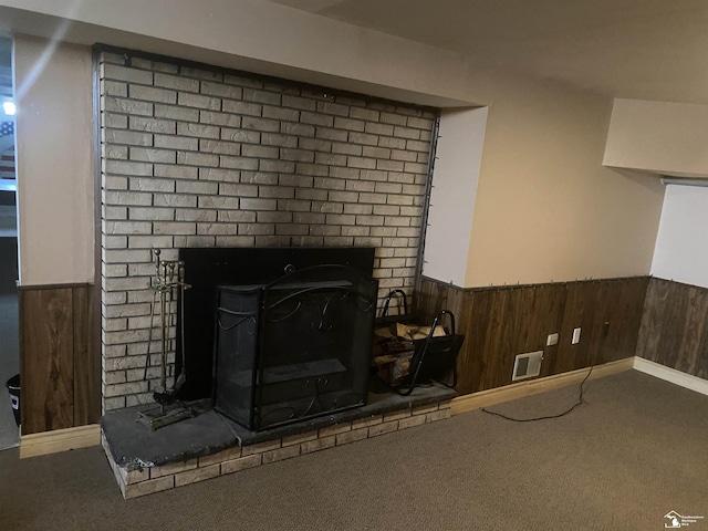 12036 S Custer, Dundee, MI 48133 - detailed view of carpet, wainscoting, wood walls, and a brick fireplace