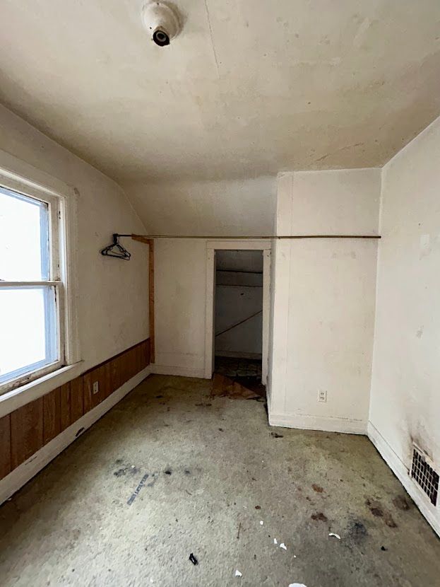 additional living space with visible vents and vaulted ceiling